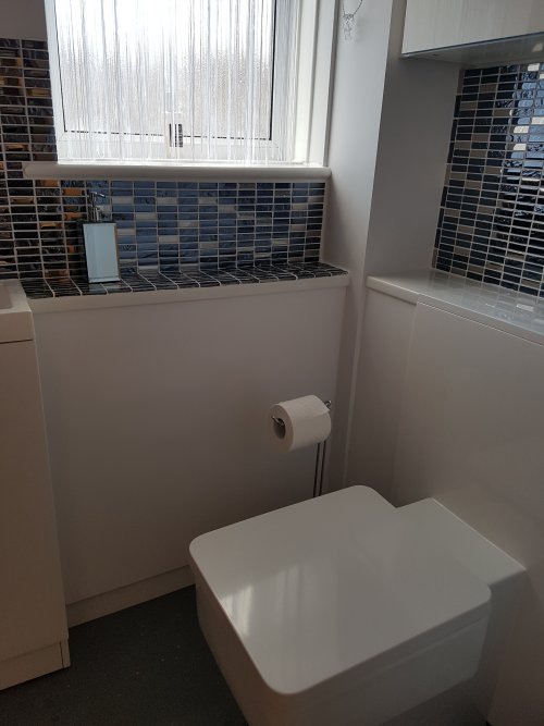 After - Cloakroom toilet and boxing in, plus tiling