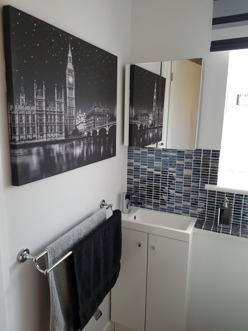 After - Sink unit, blind and towel rail wih wall art