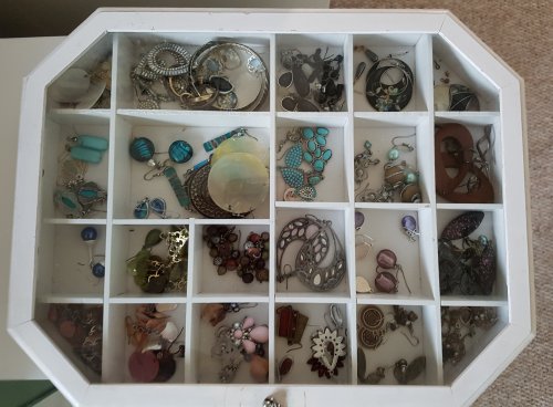 Earrings sorted by colour in compartments