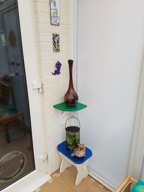 Corner shelf and table in conservatory