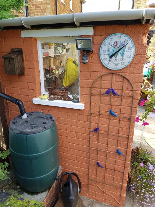 Left side - painted bird trellis/thermometer